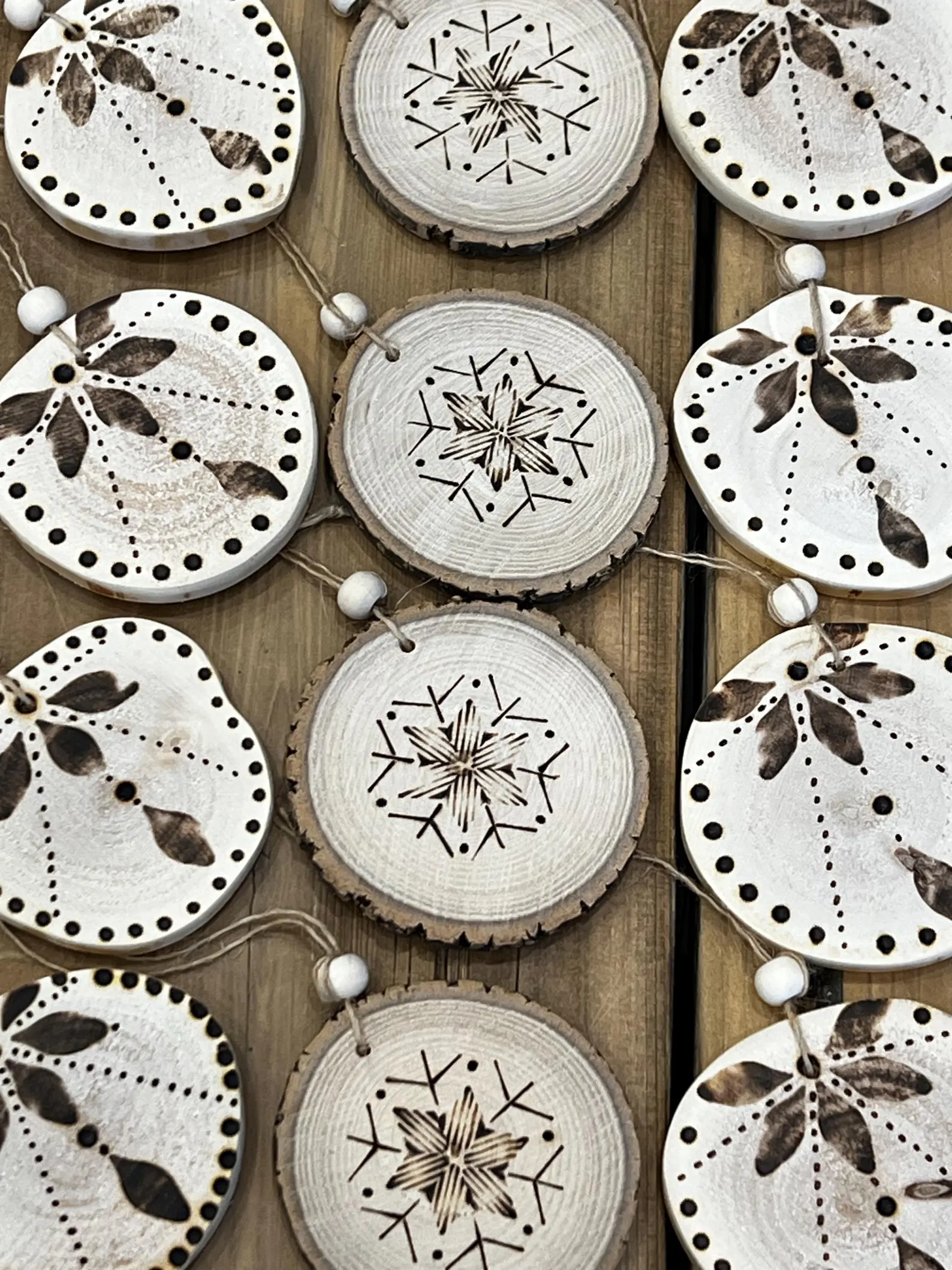 Unique handmade rustic wood burned ornament, perfect for holiday decorations, featuring a natural twine for hanging.
